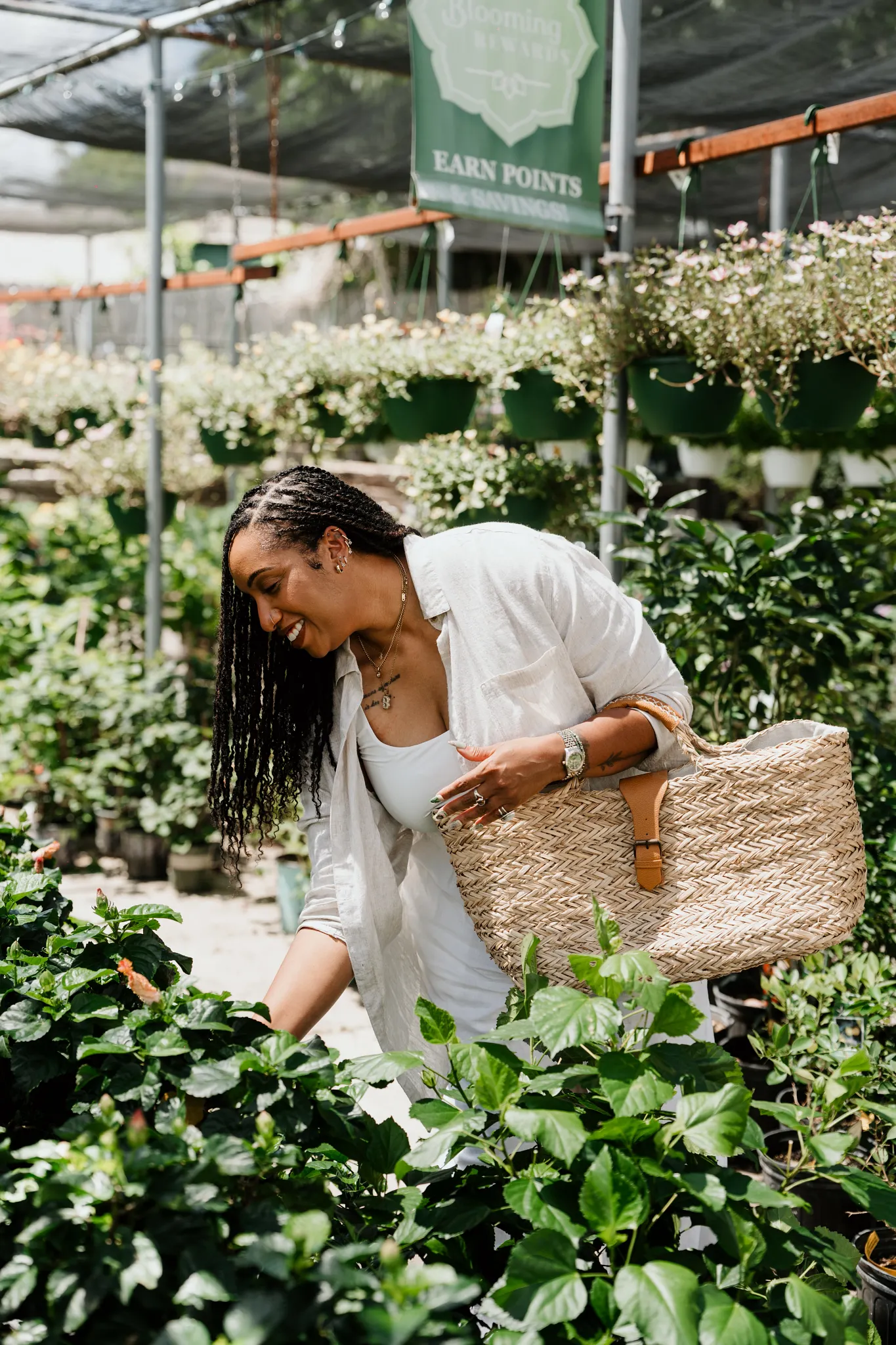 Britt browsing green plants in a plant shop