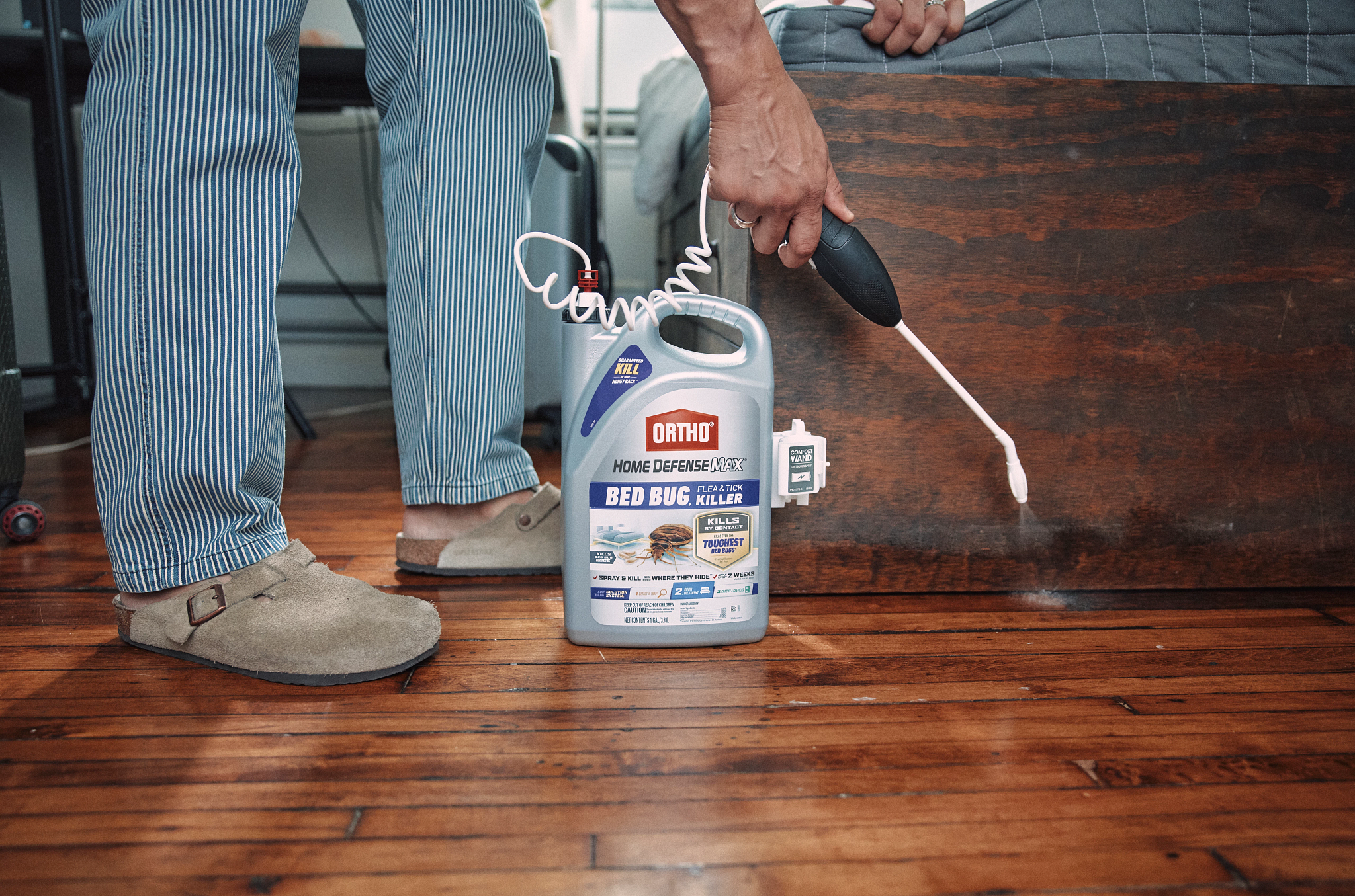 person spraying ortho indoor inside door