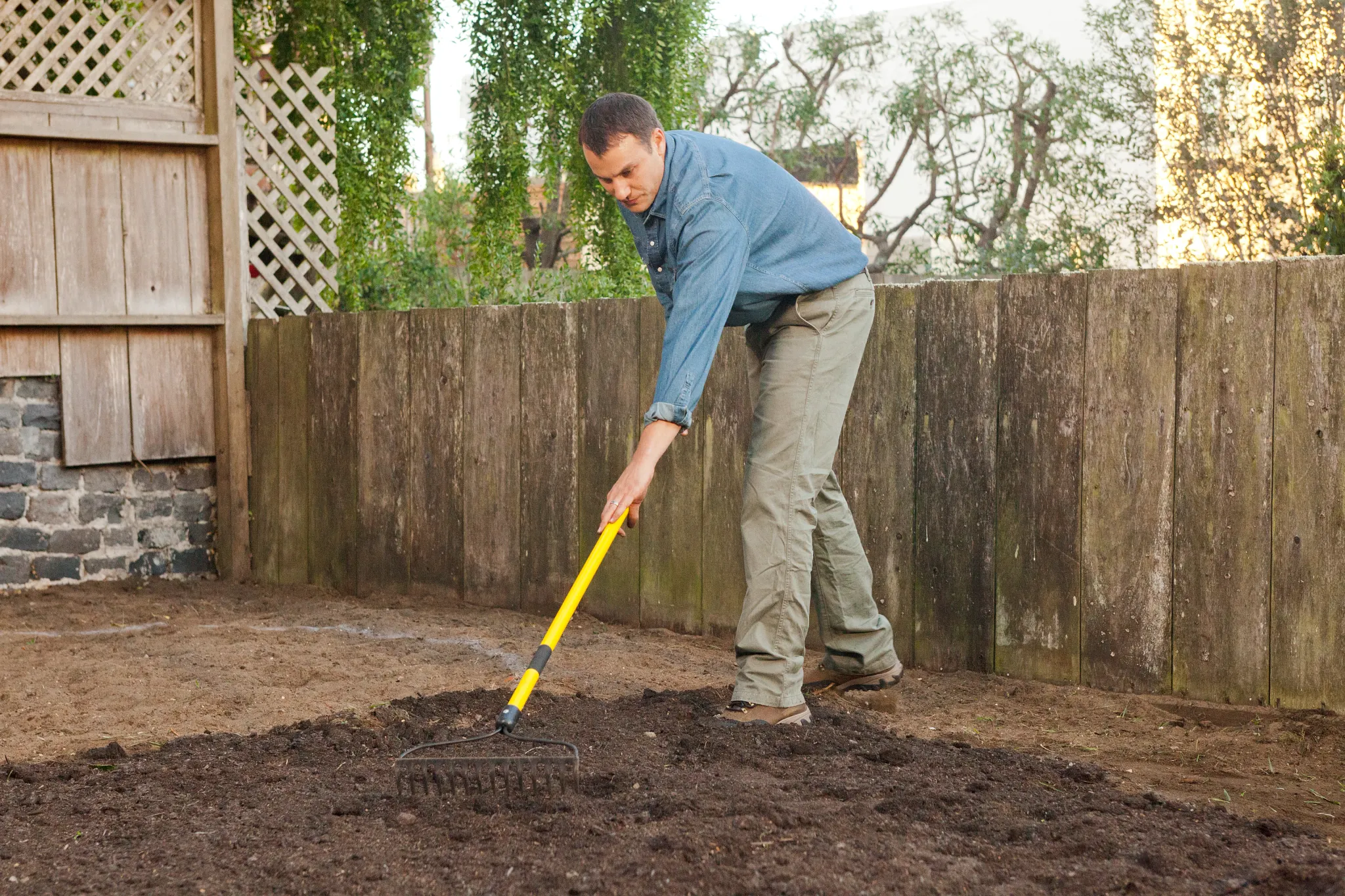 Prepping the soil with Turf Builder LawnSoil before applying grass seed
