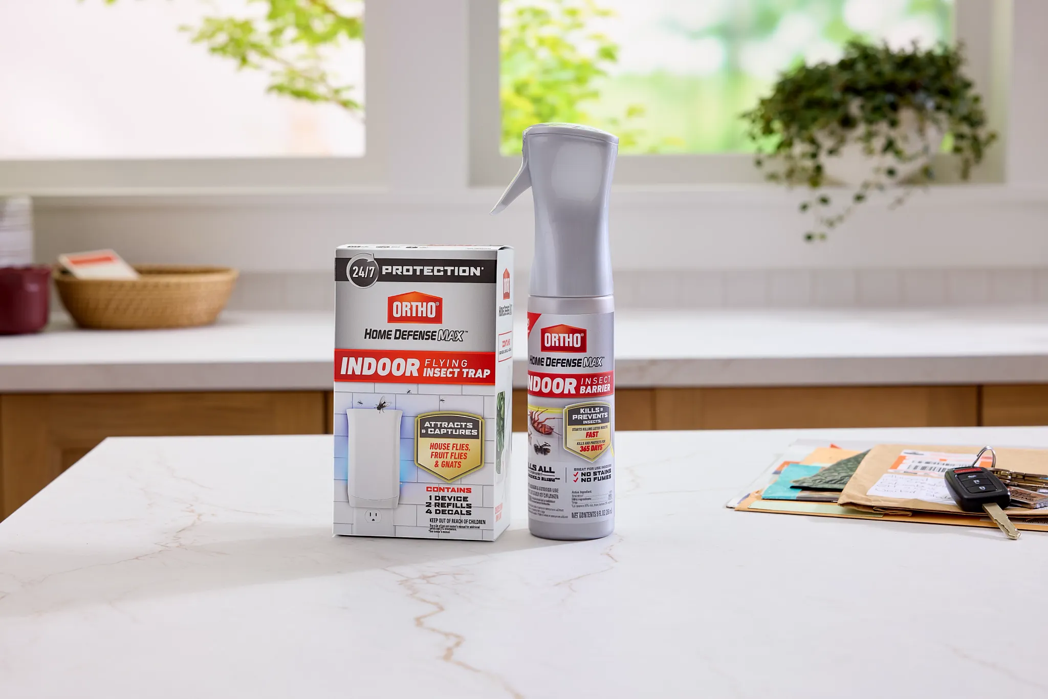 Ortho Flying Insect Trap and Ortho Home Defense MAX Flairosol sitting on a kitchen counter.