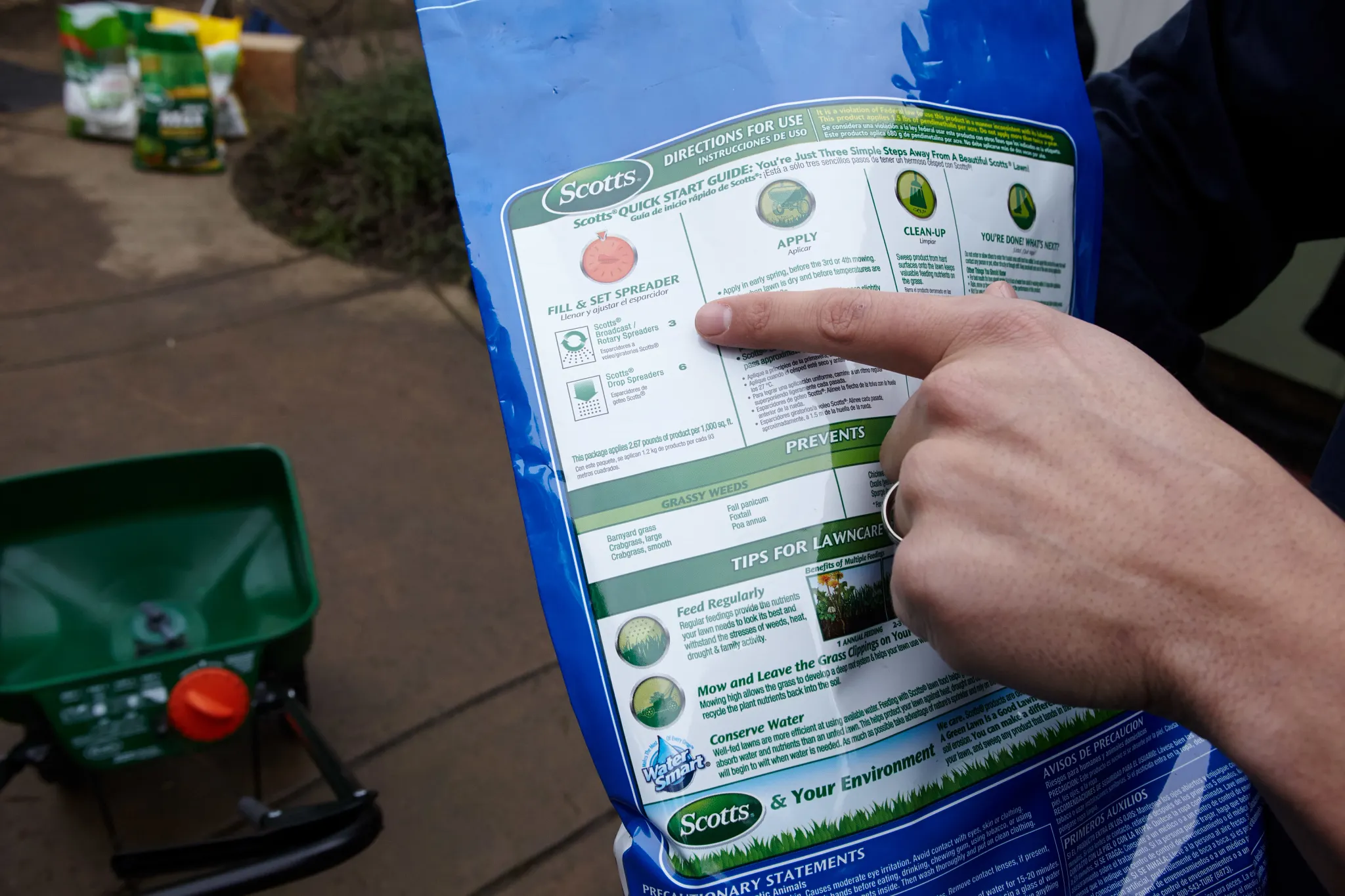 Checking spreader setting on back of Scotts lawn product bag