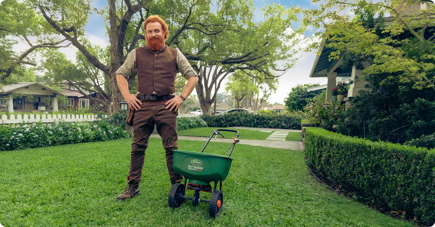 Get a custom lawn feeding plan designed by experts with over 150 years of experience. A lawn care professional stands on a healthy residential lawn with a spreader, promoting a personalized lawn assessment quiz.