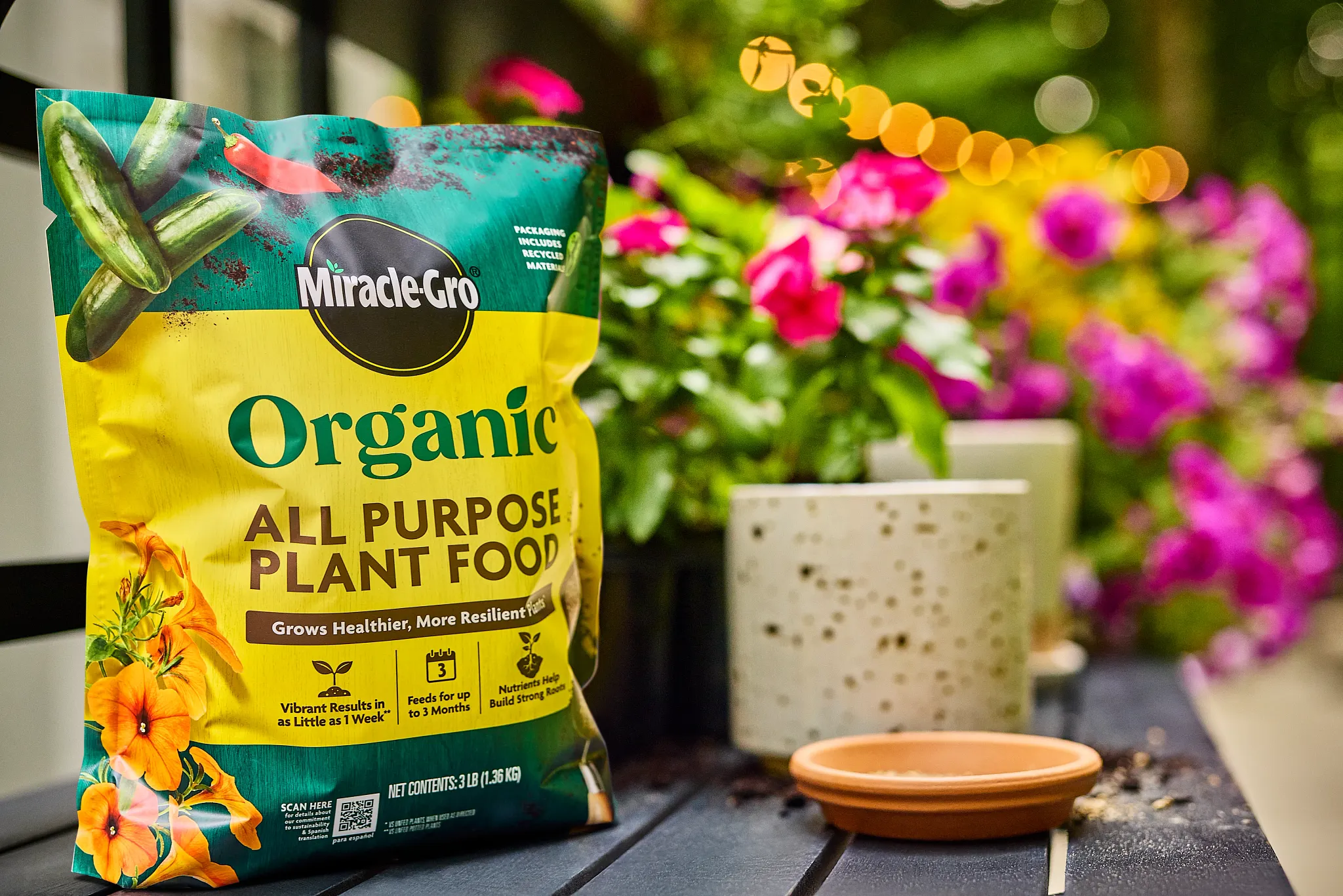 Bag of Miracle-Gro Organic All Purpose Plant Food sitting on a potting bench