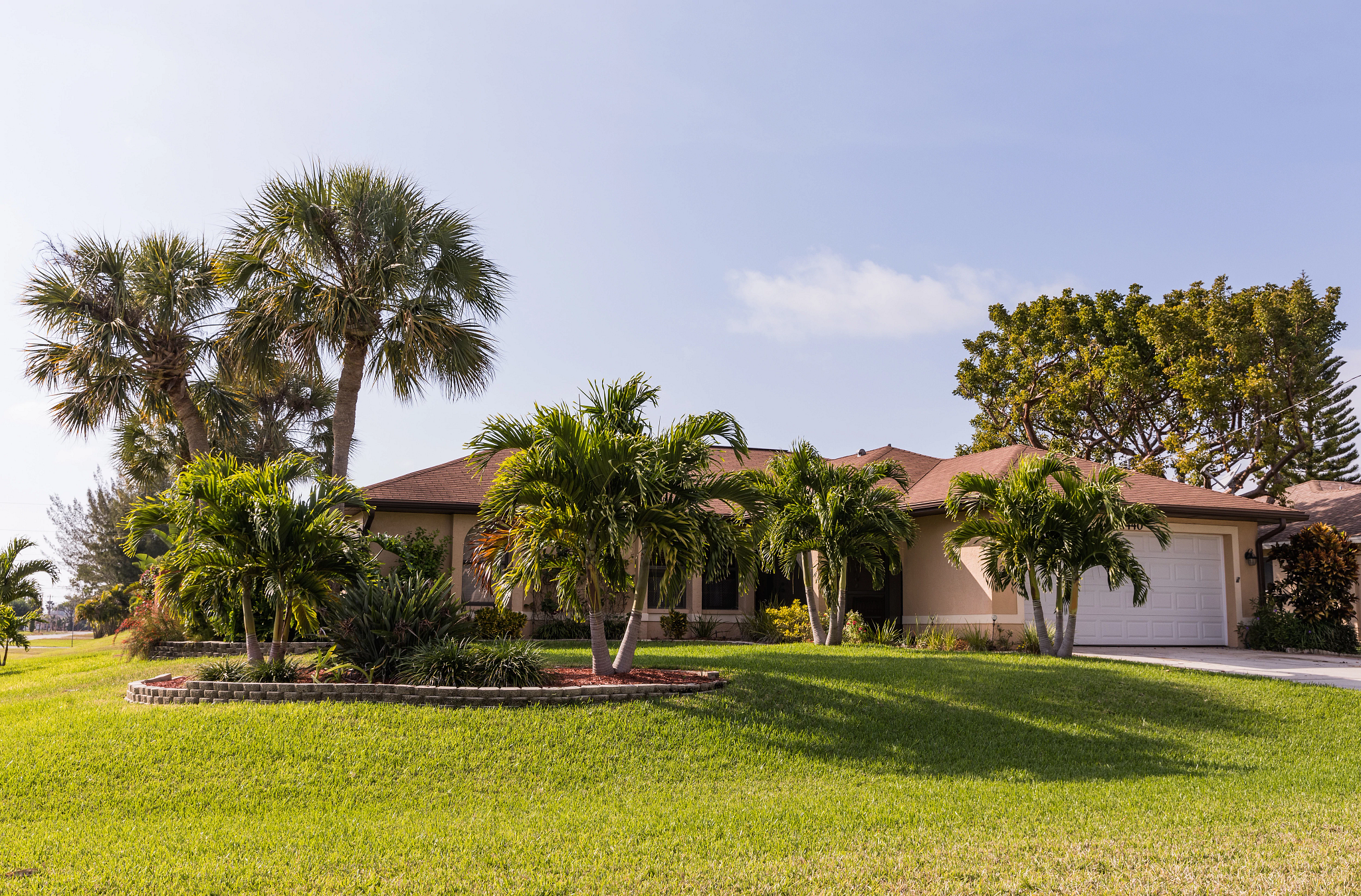 Front yard of a home on the Florida coast with a bahiagrass lawn