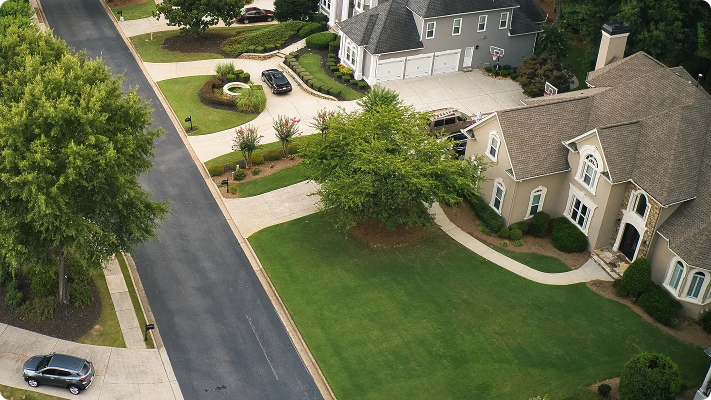 aerial view of new homes in a neighborhood with a nice big lawn