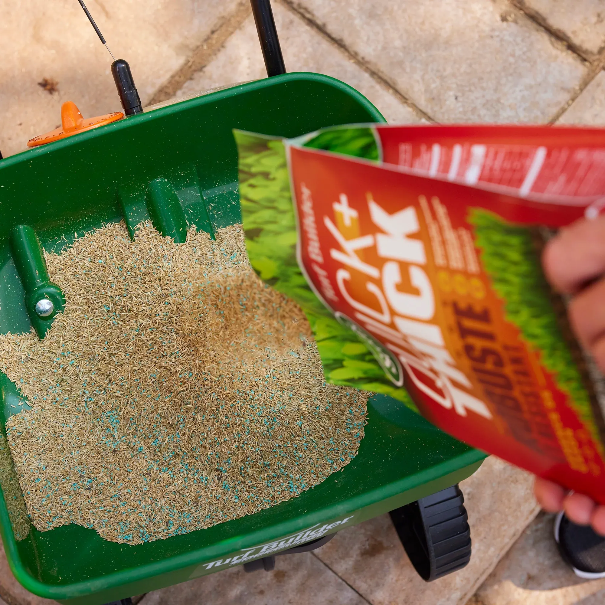 Man pours Turf Builder Sun & Shade Grass Seed in to a spreader.